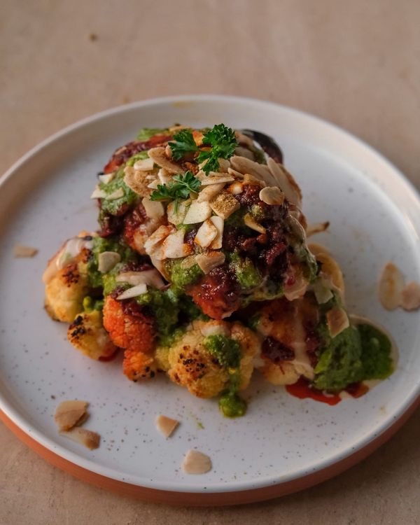Whole roasted cauliflower with tahini and harissa